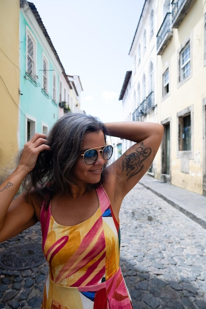 A vibrant street scene in Salvador, Bahia, with colorful colonial buildings and people dressed in traditional Afro-Brazilian clothing.
