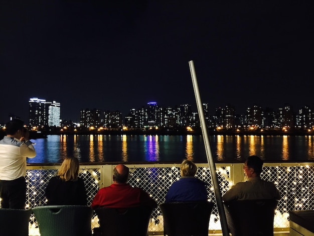 A sophisticated rooftop bar in São Paulo, featuring panoramic city views, elegant decor, stylish patrons, and premium cocktails. The scene captures the vibrant nightlife and upscale ambiance of the city's luxury scene.