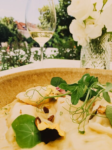 An elegant dining setting at a Michelin-starred restaurant in Brazil, featuring exquisite plating, fine wine glasses, a candlelit ambiance, and attentive waitstaff. The image evokes a sense of culinary excellence and sophisticated dining.