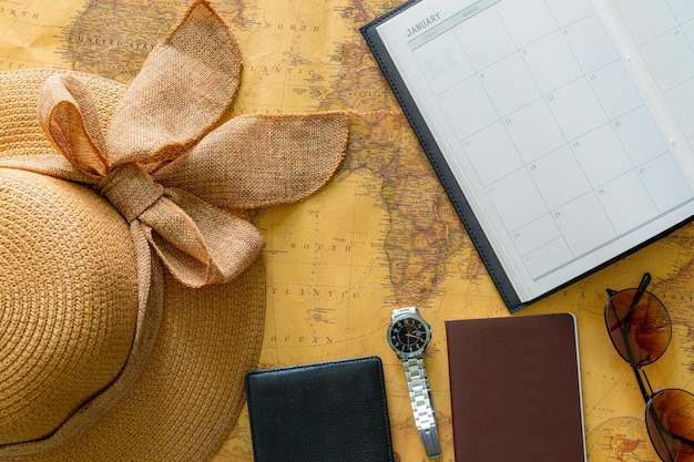 An overhead shot of a calendar with various dates circled, each marked with different flight and hotel deals, alongside a pair of sunglasses and a travel guide to Brazil.