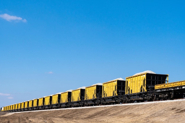 A long line of cargo trucks waiting to unload grain at a port in Santos, Brazil, illustrating the logistical challenges of exporting agricultural products, with containers and ships visible in the background.
