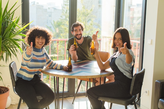 A diverse group of Brazilian employees are sitting around a table, engaged in a lively negotiation. There are documents spread across the table, and the atmosphere is cooperative and productive. The image conveys the importance of collective bargaining and agreements in the modern workplace.