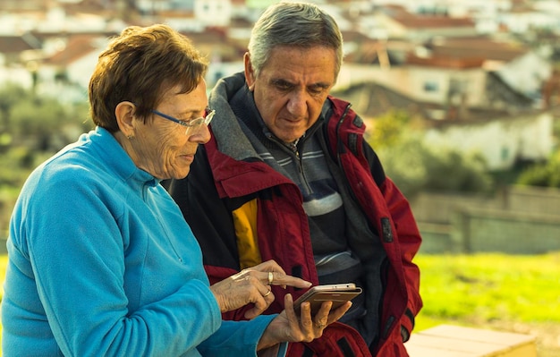 A close-up shot of a census worker interviewing a resident in a rural area of Brazil. The worker is holding a tablet and the resident is smiling and engaged.