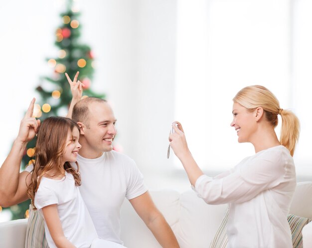 A family happily receiving the keys to their new home. The house is modern and well-lit, and the family is smiling and embracing each other. The scene conveys a sense of joy, accomplishment, and financial stability.