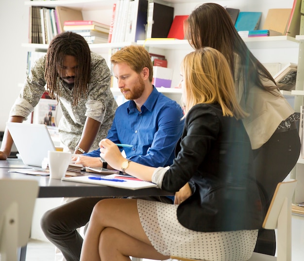 A diverse group of professionals working collaboratively in a modern office, representing the skilled workforce enabled by increased access to higher education.
