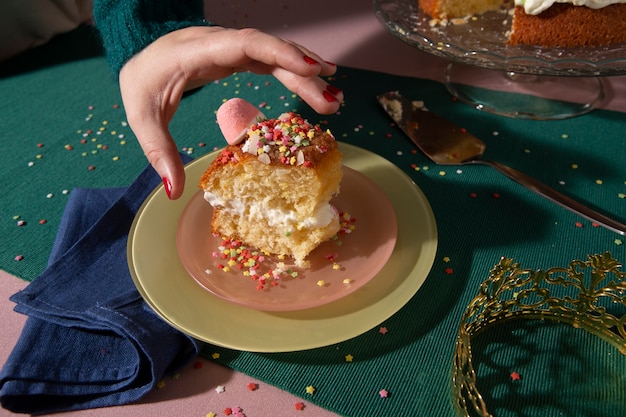 A slice of creamy cornmeal cake being served with a dollop of whipped cream and a sprig of mint on a plate, showcasing its moist texture and golden crust.