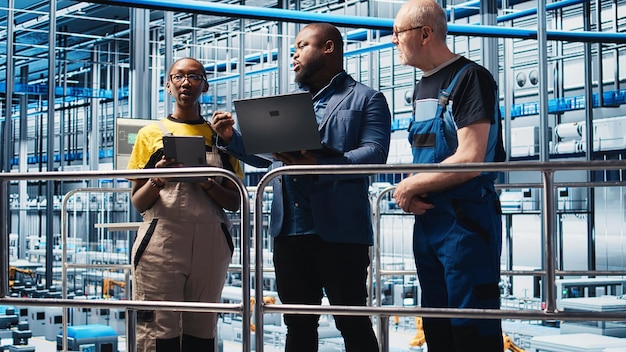 A diverse group of engineers and technicians collaborating around a large industrial machine, reviewing data and making adjustments. The scene radiates teamwork, innovation, and technical expertise.